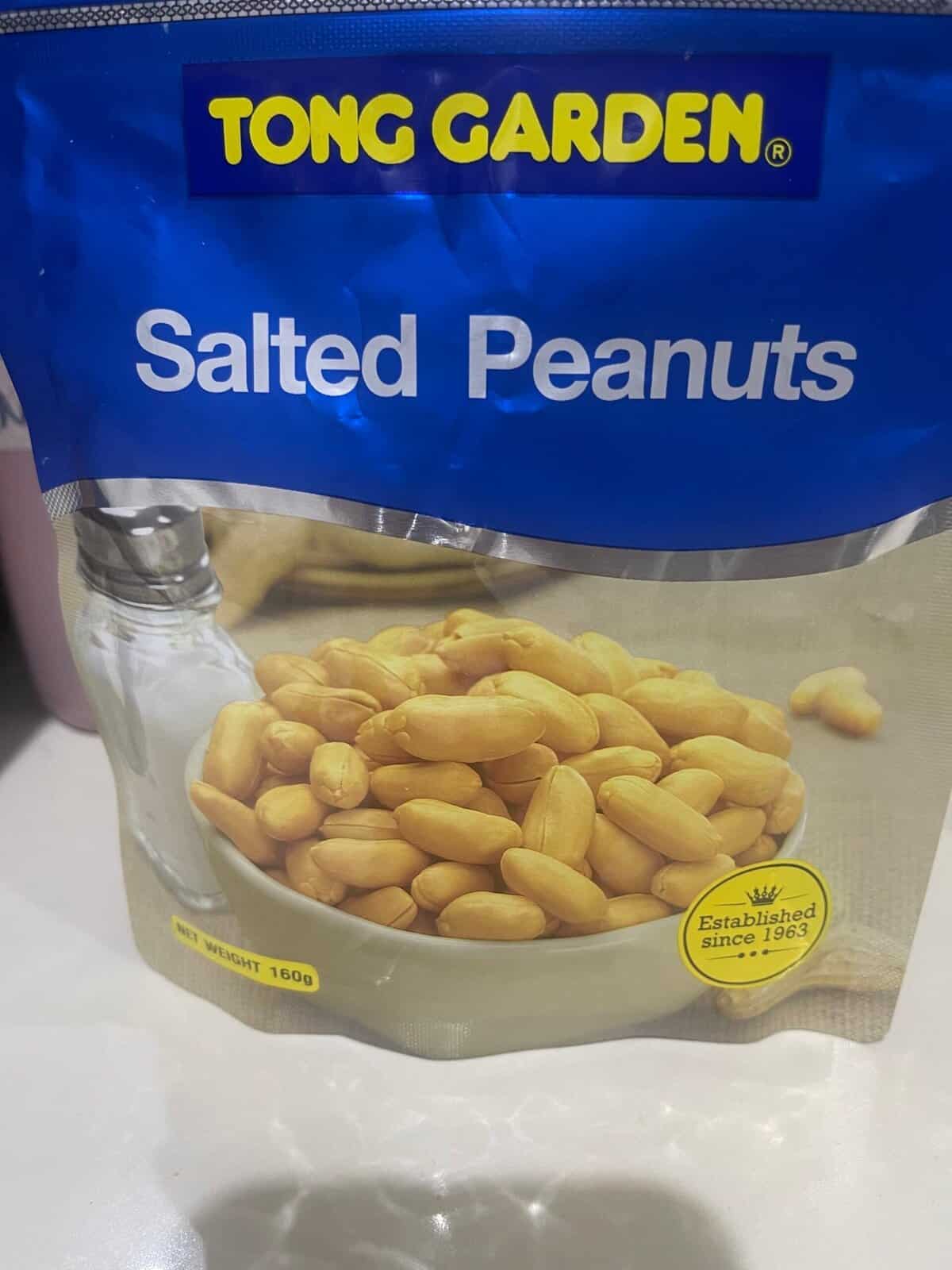 A blue packet labeled "Tong Garden Salted Peanuts" with a bowl of peanuts pictured on the front.