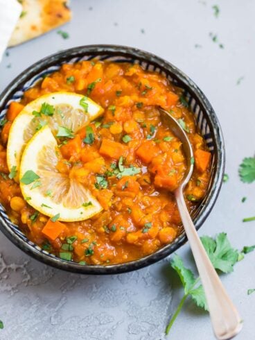 a bowl of red lentil curry carrot soup