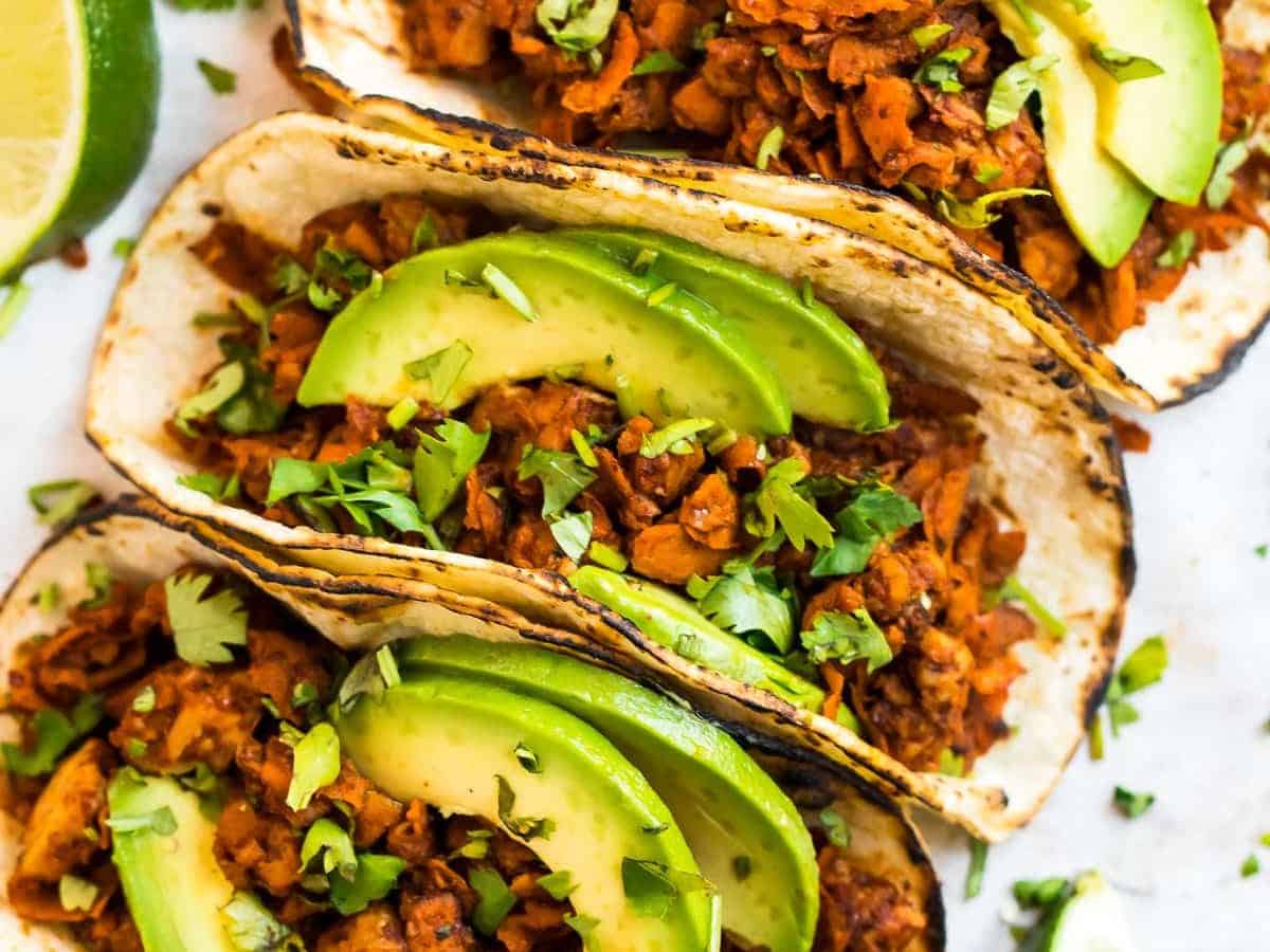 Tempeh tacos topped with avocado slices