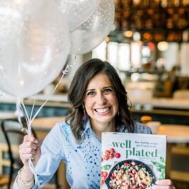 Erin Clarke with The Well Plated Cookbook and Balloons