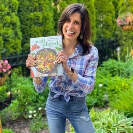 Erin Clarke holding finished copy of The Well Plated Cookbook