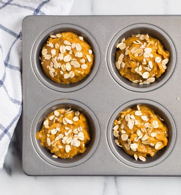 Batter in a muffin pan with oats