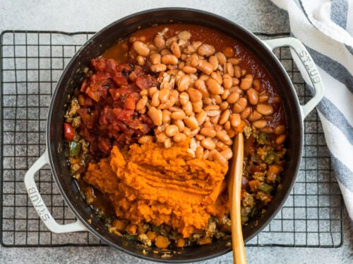Beans, pumpkin, turkey, and veggies in a Dutch oven