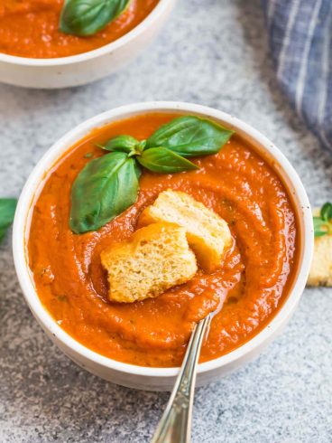 A bowl of Instant Pot tomato soup with croutons and basil