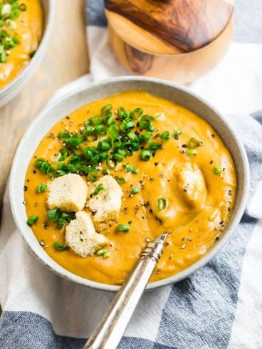 A bowl of vegan potato soup with croutons