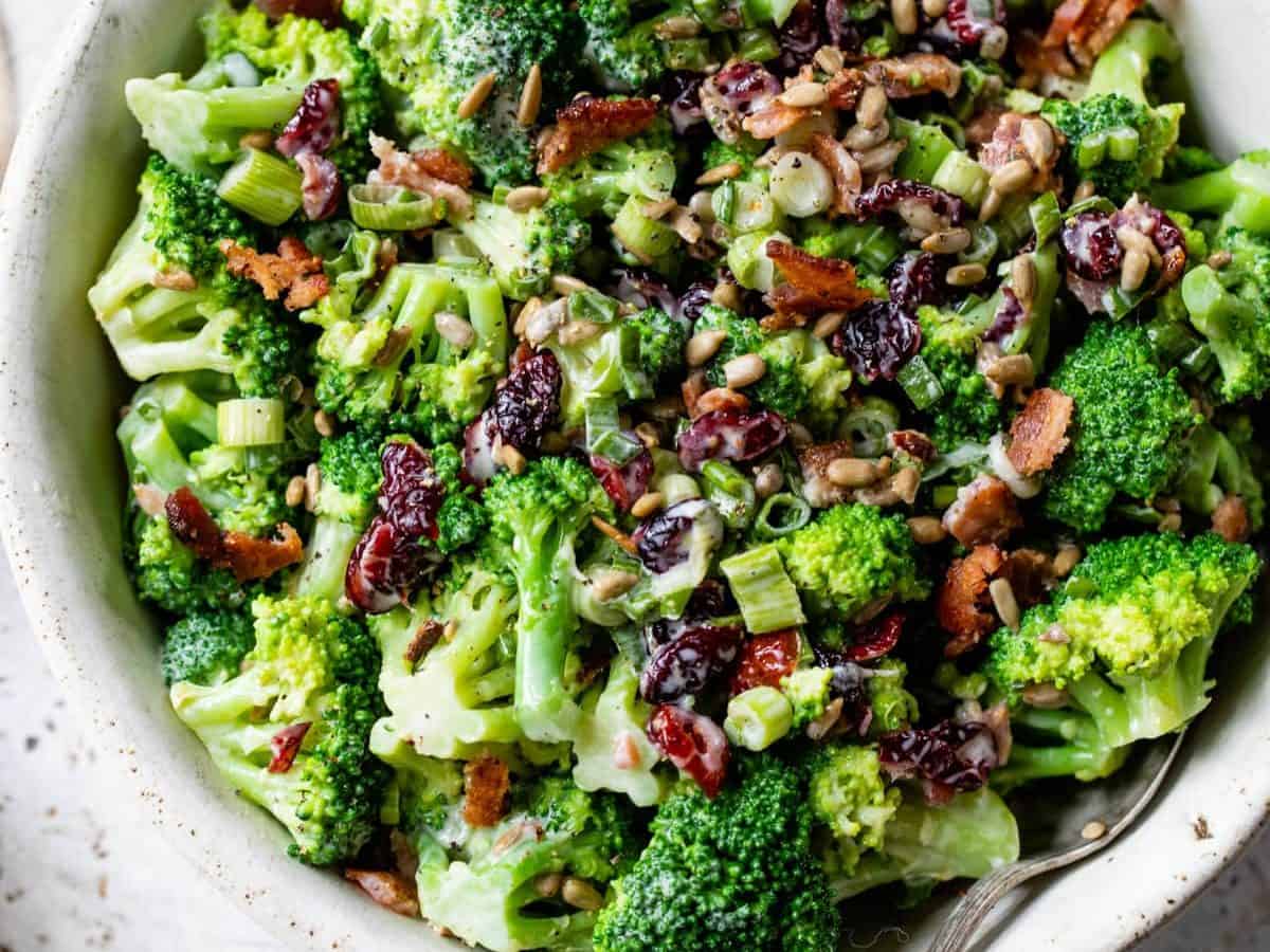 Overhead view of broccoli bacon salad in serving bowl with spoon