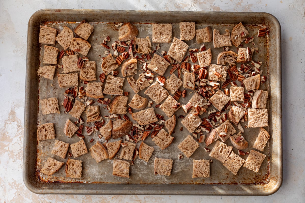 Pecans and bread on baking sheet