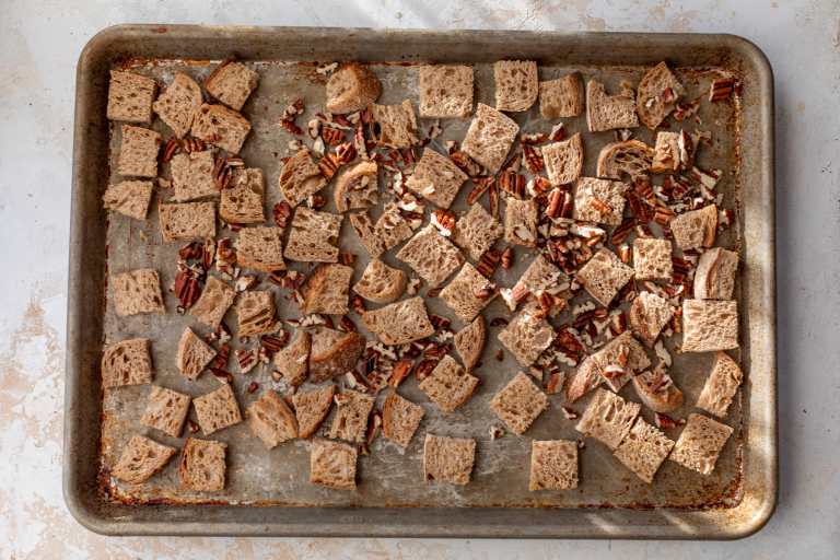 Pecans and bread on baking sheet