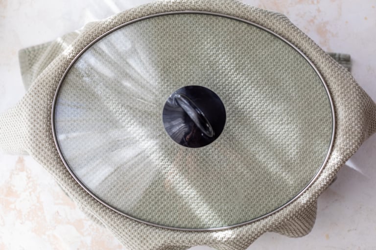 Kitchen towel and cover on slow cooker