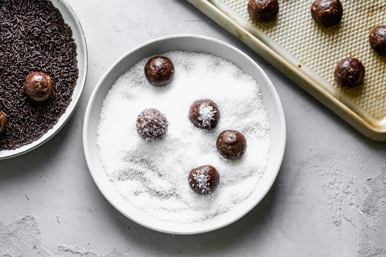 Bourbon balls being rolled in sugar