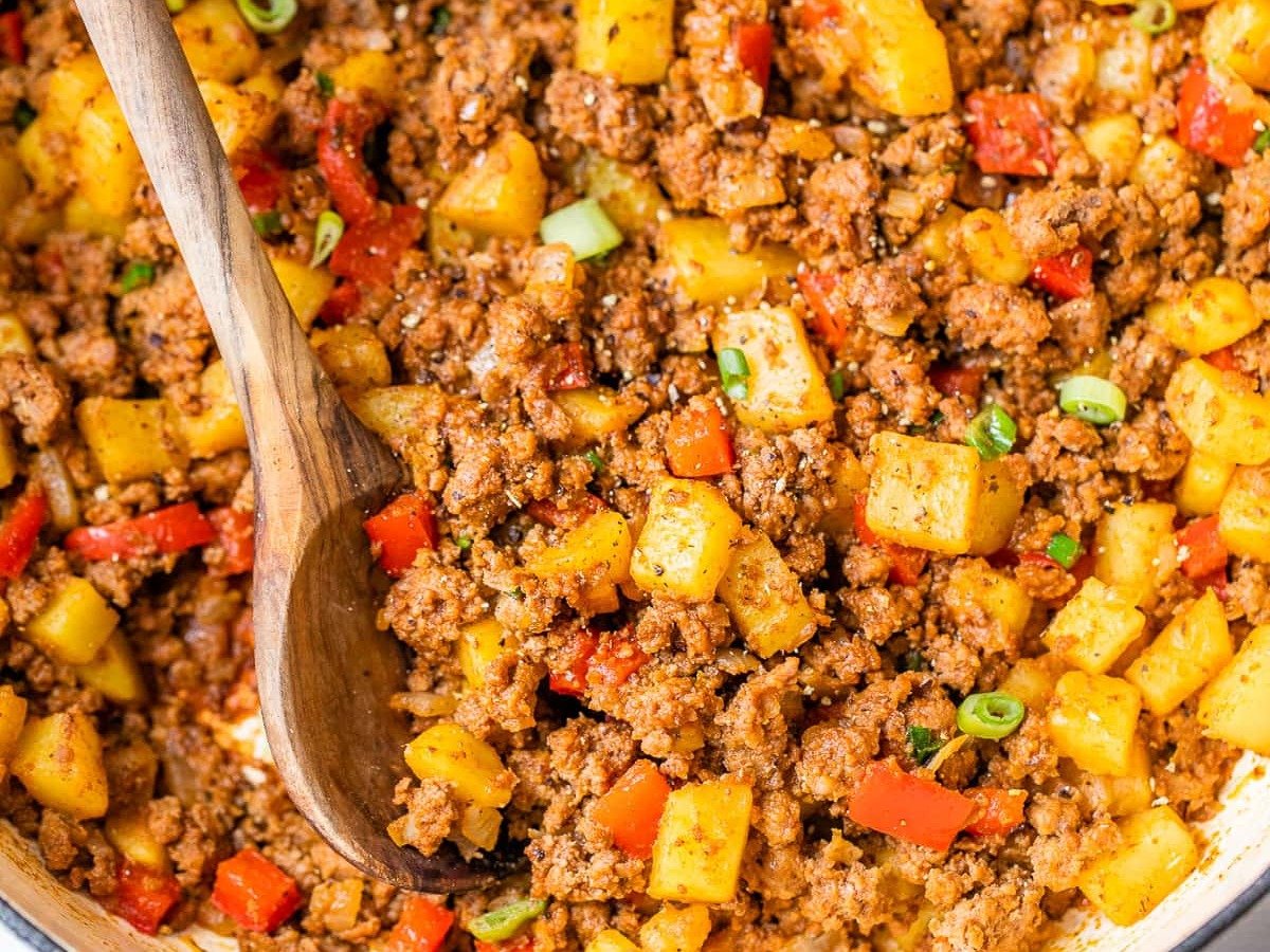Ground beef and potatoes with red peppers in a pot
