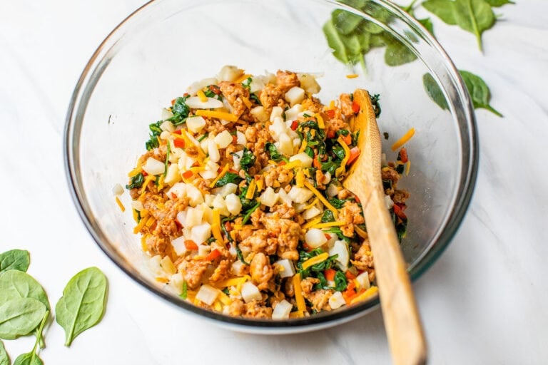 Veggies, sausage, and cheese in a bowl