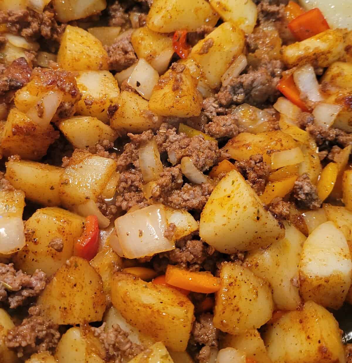 Diced potatoes, ground beef, onions, and bell peppers cooked together with spices.