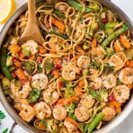 An easy, healthy Lemon Garlic Shrimp Pasta with Parmesan. Frozen stir fry veggies make this recipe extra quick with minimal prep. Ready in 30 minutes and a total crowd pleaser! Simple, lightly spicy, and perfect for date night or easy healthy dinners.