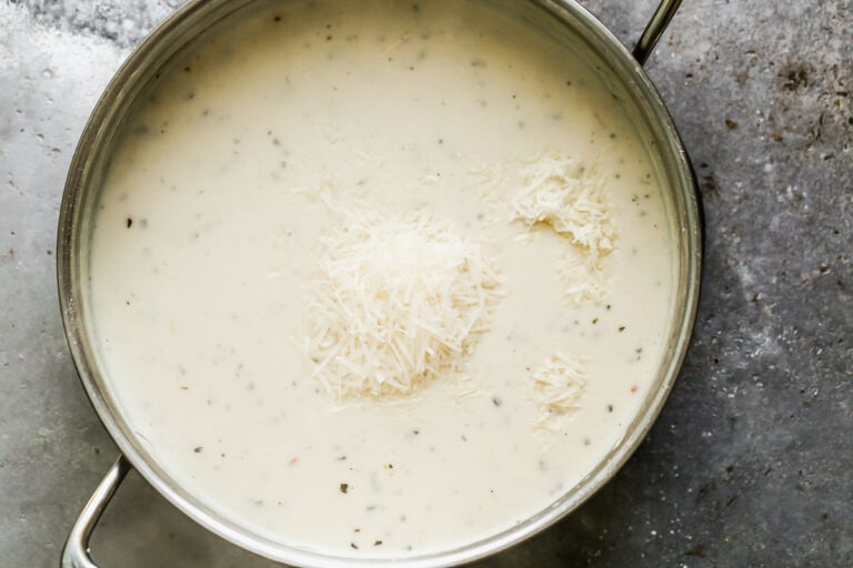 Cheese being added to Alfredo sauce