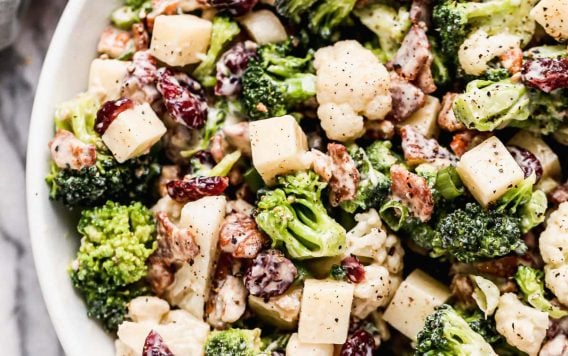 Broccoli cauliflower salad in a bowl with bacon
