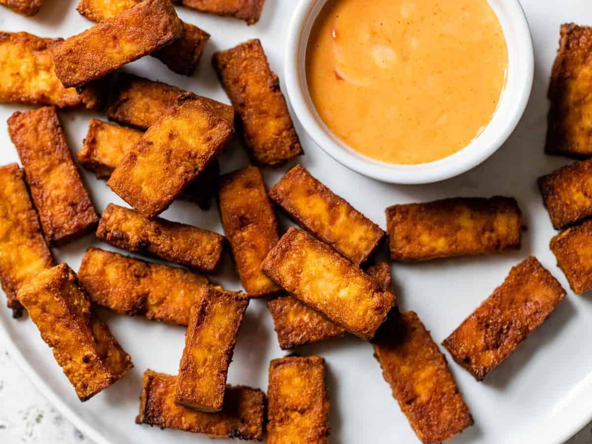 Air fryer tofu on a plate with dip