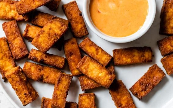 Air fryer tofu on a plate with dip