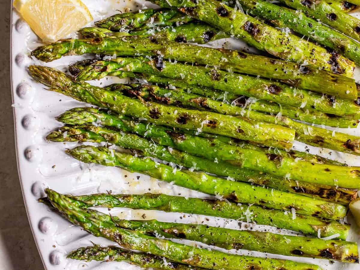 Grilled asparagus with lemon and Parmesan on a plate