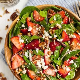 Spinach Strawberry Salad in bamboo bowl.