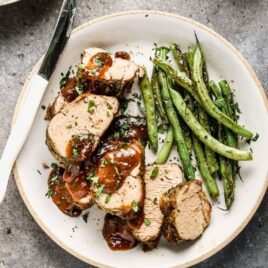 Instant Pot Pork Tenderloin on white plate.