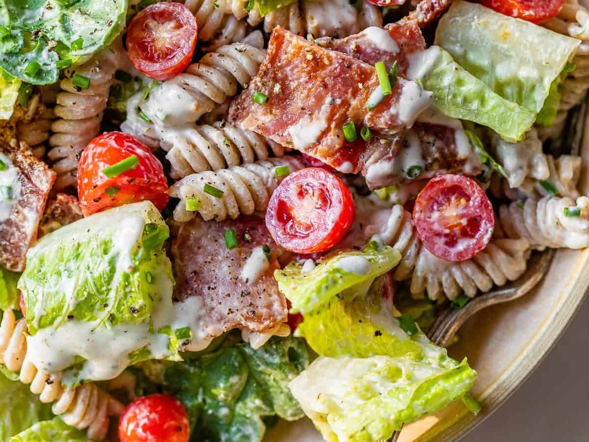 blt pasta salad with dressing and spinach