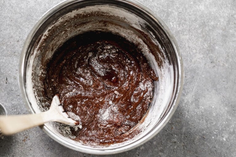 folding dry ingredients into wet brownie batter ingredients