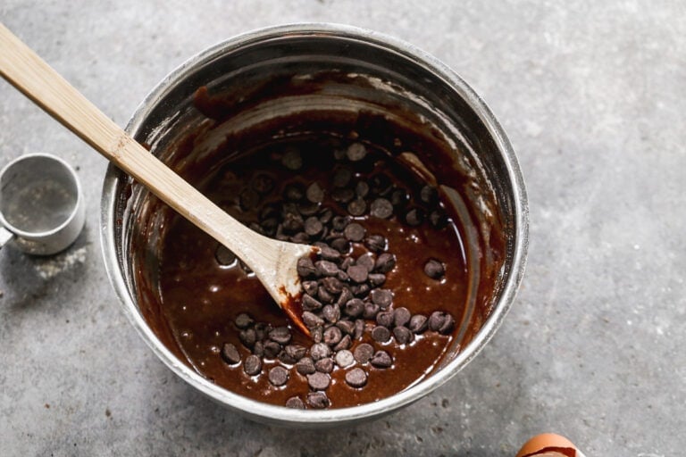 mixing dark chocolate chips into brownie batter