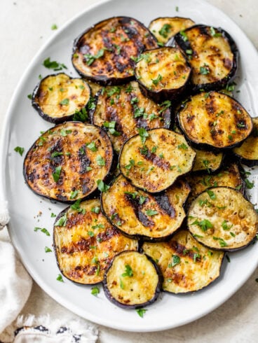 grilled eggplant with seasoning on a plate for dinner