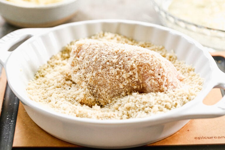 Chicken being dipped in breadcrumbs