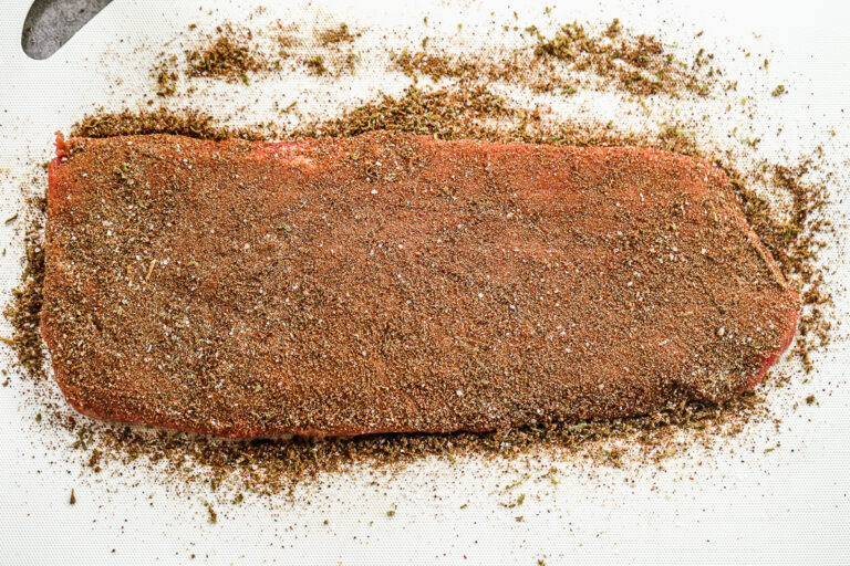 Beef fajitas seasoning over a piece of steak