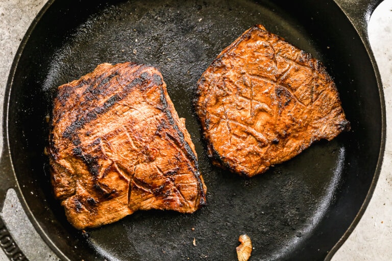 Two steaks in a cast iron skillet