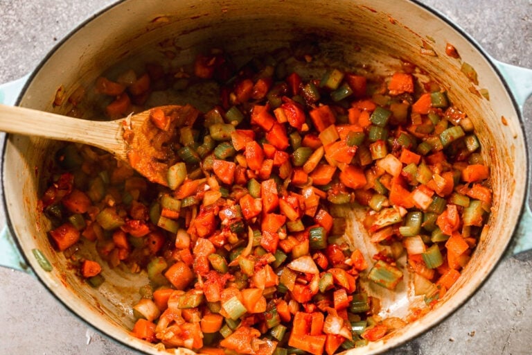 Vegetables being sauteed in a Dutch oven