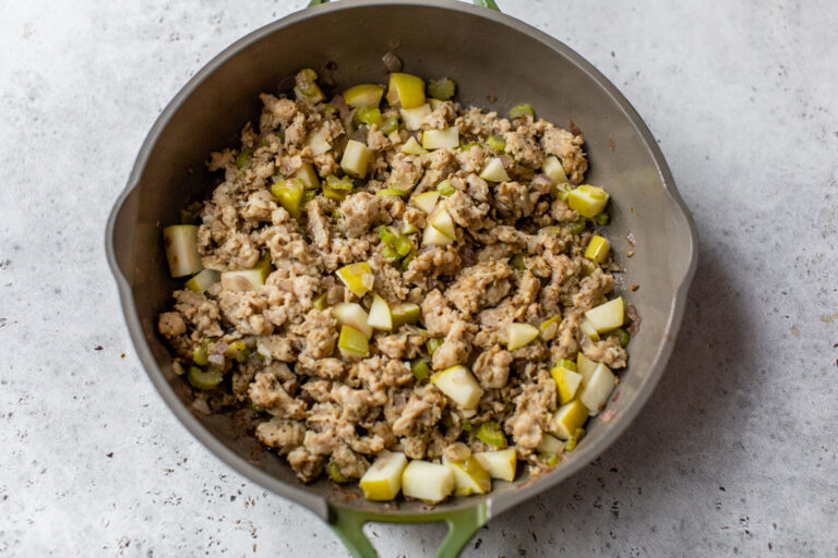 sausage, celery, and onions being sautéed in a skillet