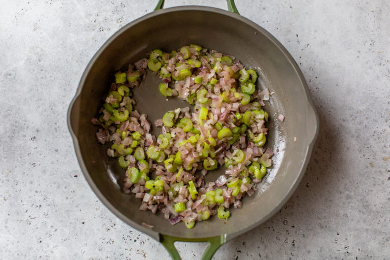 a mixture of onions and celery in a skillet