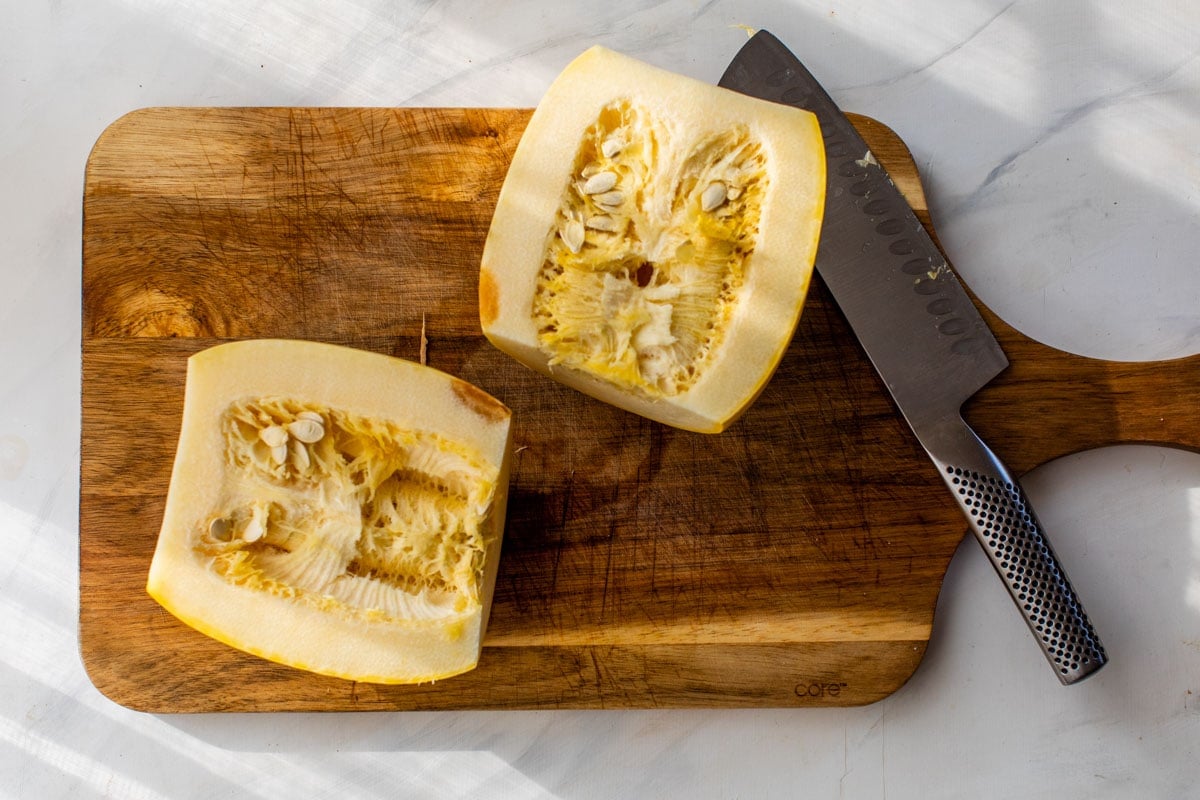 Halved spaghetti squash on cutting board