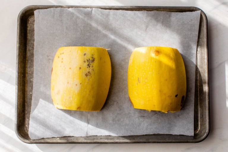 Spaghetti squash cut side down on baking sheet
