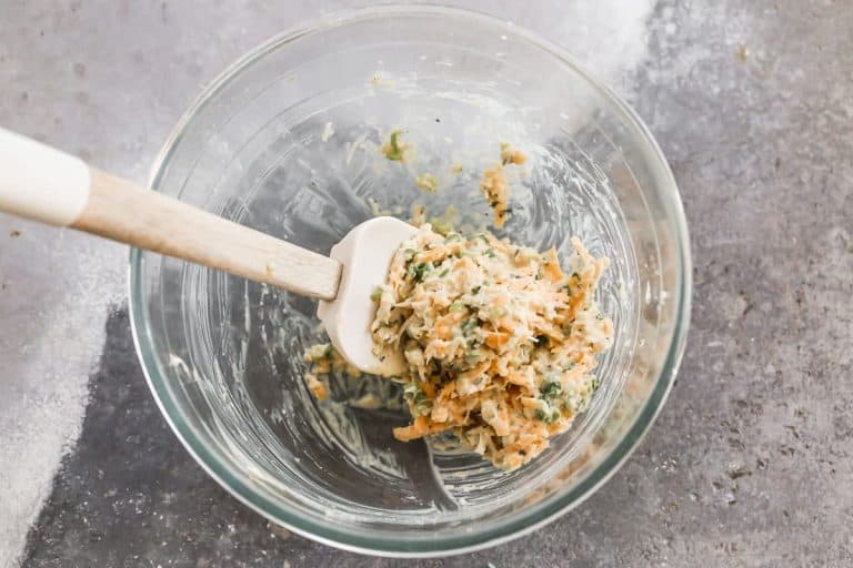 Cheese, yogurt, egg yolk, and spices in a bowl