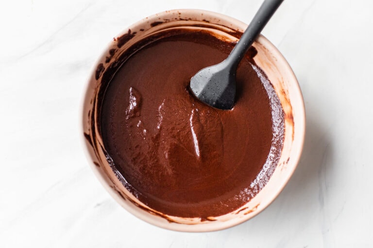 A bowl of melted red wine chocolate ganache for wine infused truffles