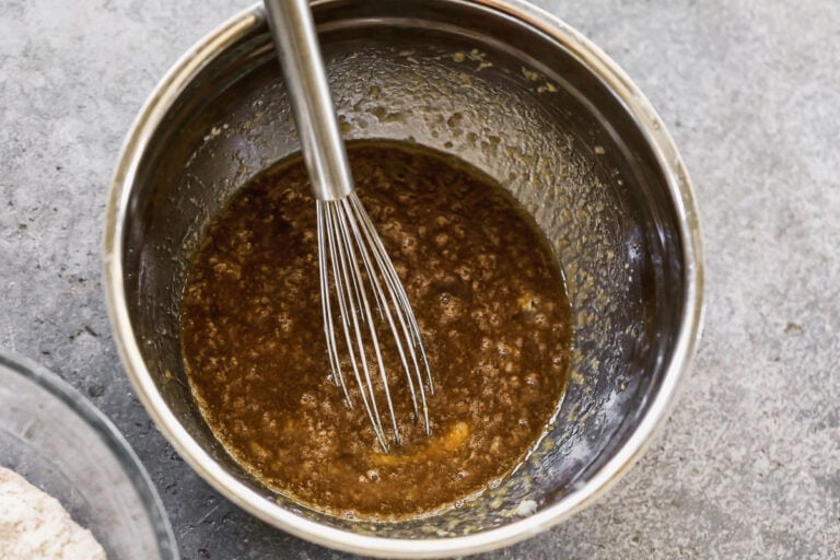 mixing together wet ingredients for sweet potato cookies with a whisk