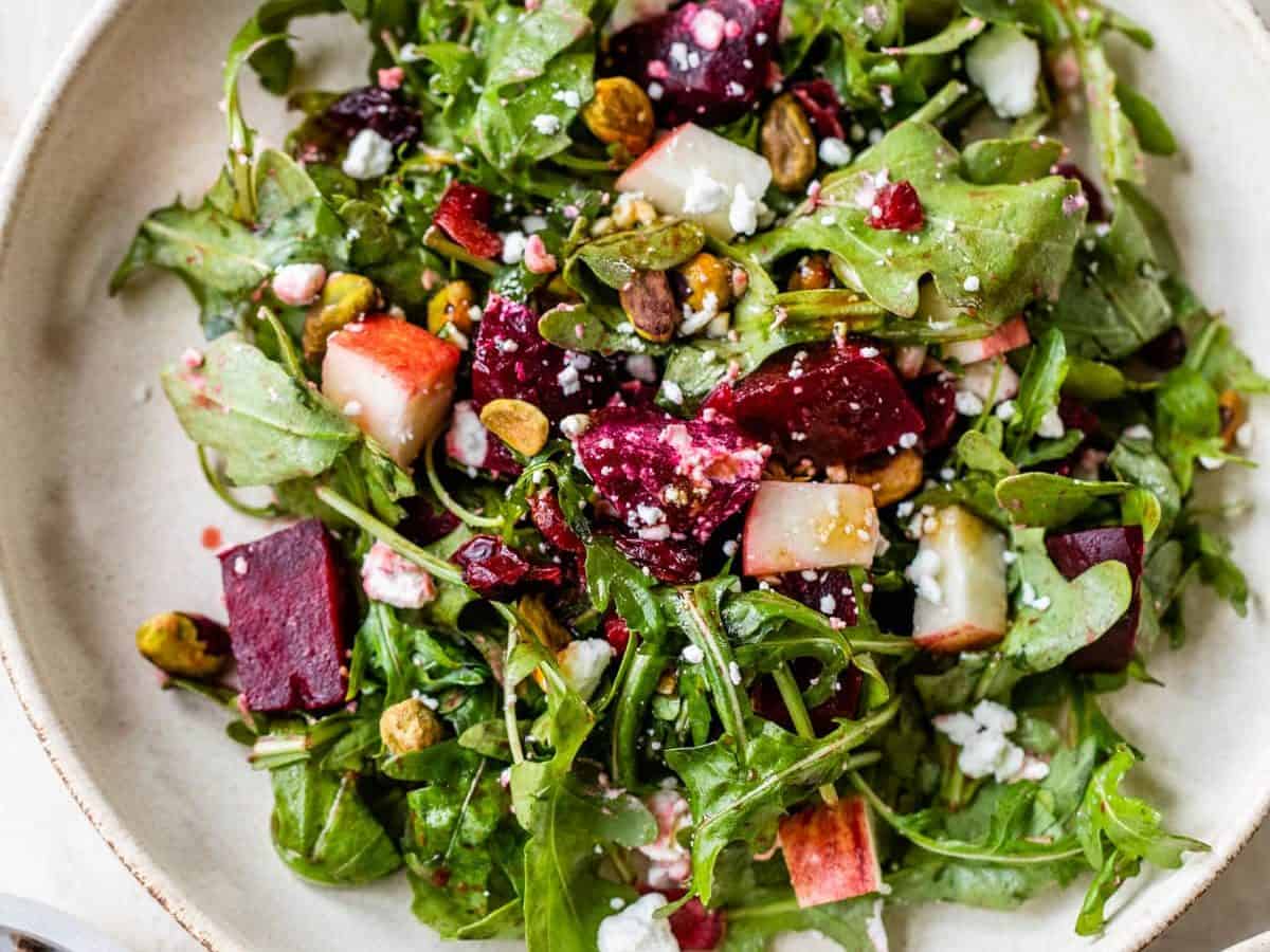 A white plate with beet salad