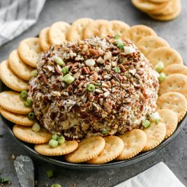 Pecans on a pineapple cheese ball with crackers