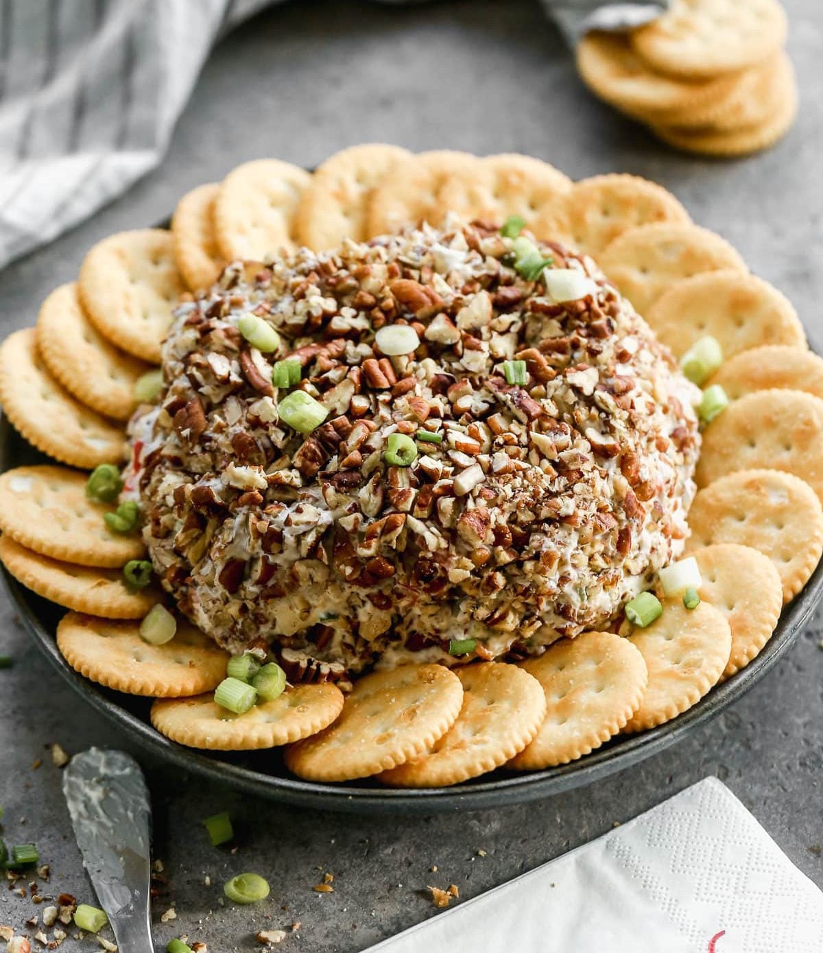 Pecans on a pineapple cheese ball with crackers