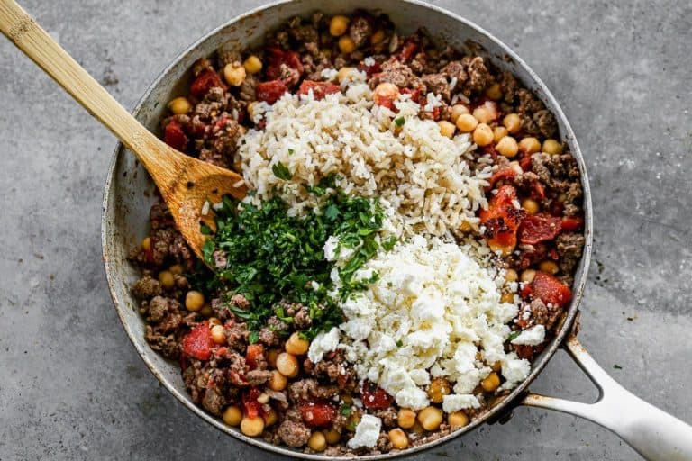 Ingredients for Greek stuffed peppers in a skillet