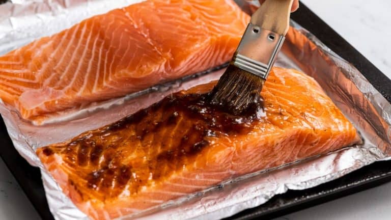 brushing balsamic glaze onto fresh pieces of salmon