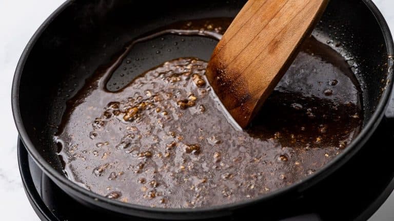 Balsamic glaze being stirred and reduced in a skillet