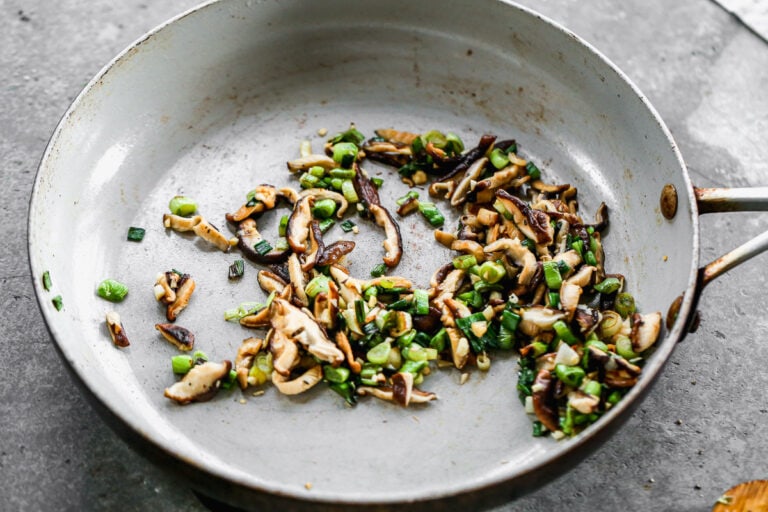 sautéed green onions, garlic, and mushrooms in a skillet