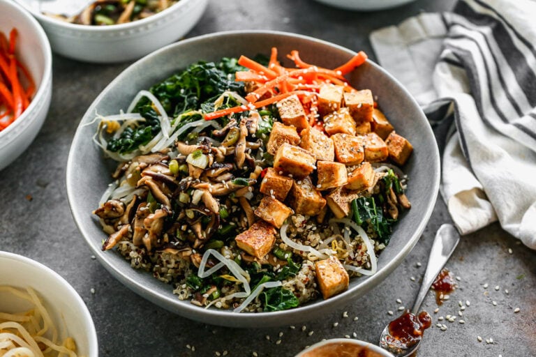 a large vegetarian bibimbap bowl with kale, quinoa, tofu, and shiitake mushrooms