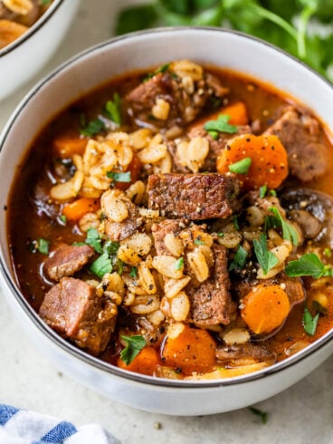 Beef barley soup with carrots in a bowl