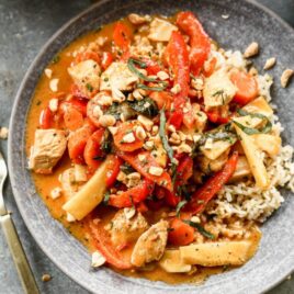Panang curry on a plate with rice and peanuts